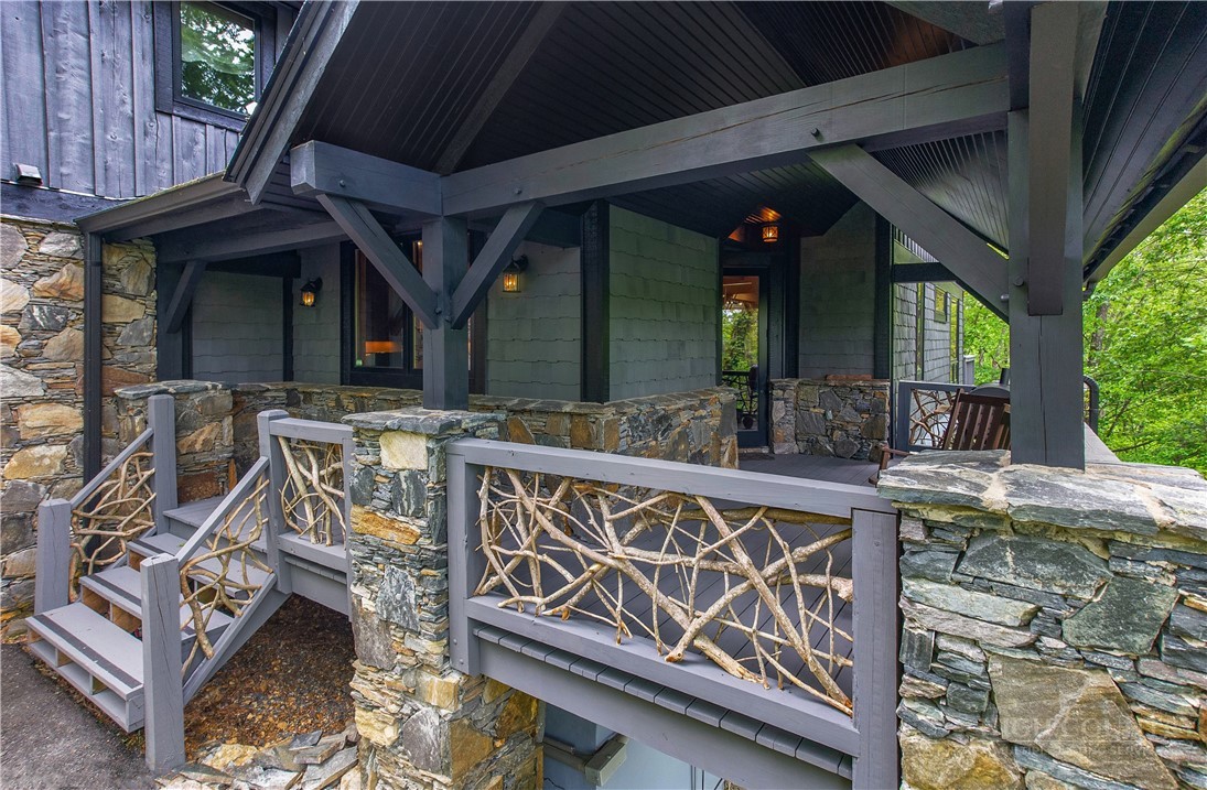 161 Hump View Trail Banner Elk, NC 28604 - Photo 8 of 50 a view of a patio with table and chairs a barbeque with wooden fence