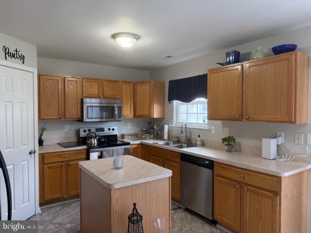 5534 Rockfish Way Clinton, MD 20735 - Photo 16 of 46 a kitchen with stainless steel appliances a sink stove refrigerator and cabinets