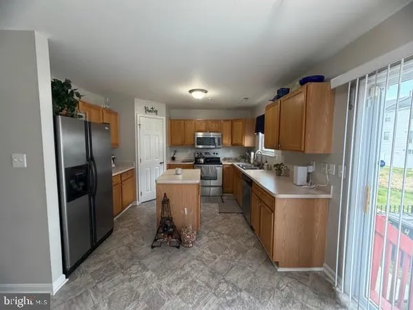 a kitchen with refrigerator and cabinets