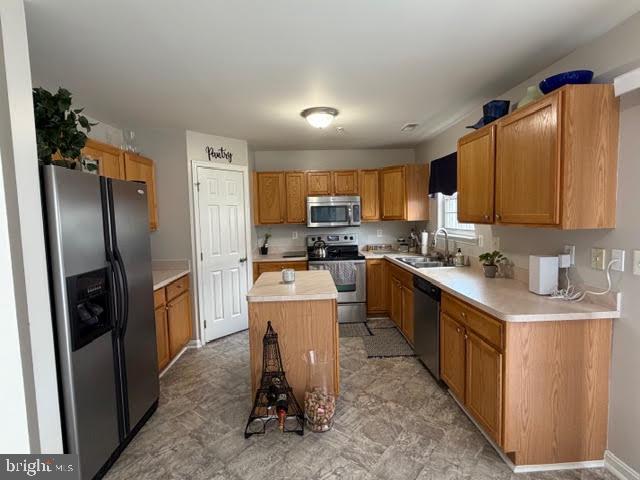 5534 Rockfish Way Clinton, MD 20735 - Photo 22 of 46 a kitchen with stainless steel appliances granite countertop a refrigerator stove microwave and sink
