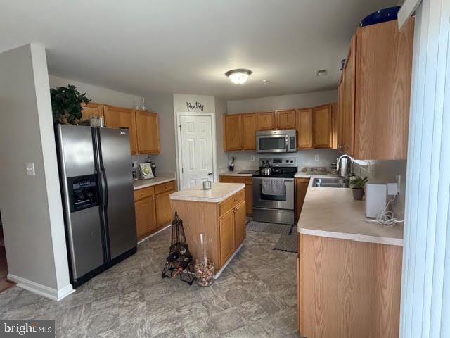 5534 Rockfish Way Clinton, MD 20735 - Photo 23 of 46 a kitchen with stainless steel appliances granite countertop a refrigerator a stove a sink and a microwave