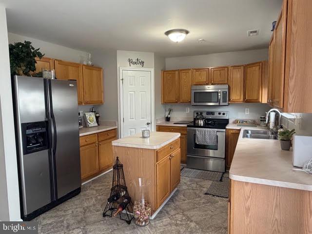 5534 Rockfish Way Clinton, MD 20735 - Photo 24 of 46 a kitchen with a sink a refrigerator and a stove top oven