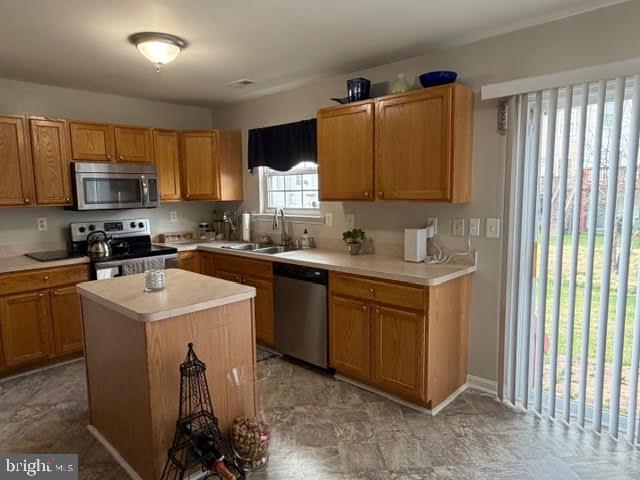 5534 Rockfish Way Clinton, MD 20735 - Photo 26 of 46 a kitchen with stainless steel appliances granite countertop a sink a stove a refrigerator cabinets and a window