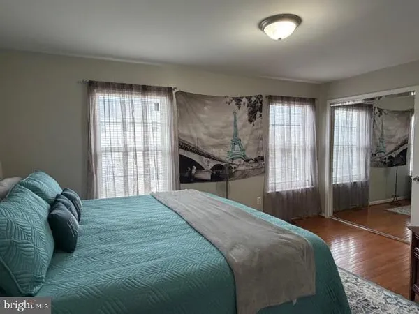 a bedroom with a bed and a large window