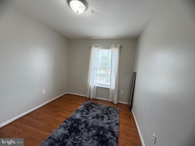 5534 Rockfish Way Clinton, MD 20735 - Photo 36 of 46 a view of a livingroom with wooden floor and a window