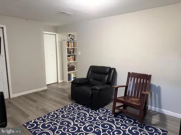 a living room with furniture and a book shelf