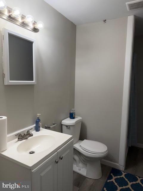 5534 Rockfish Way Clinton, MD 20735 - Photo 41 of 46 a bathroom with a toilet a sink and mirror