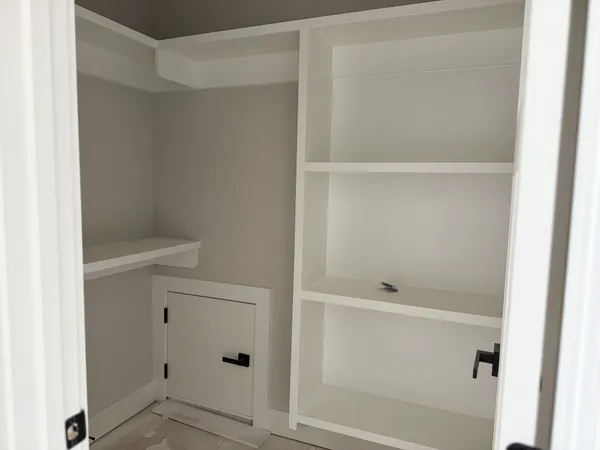 an empty room with windows and closet