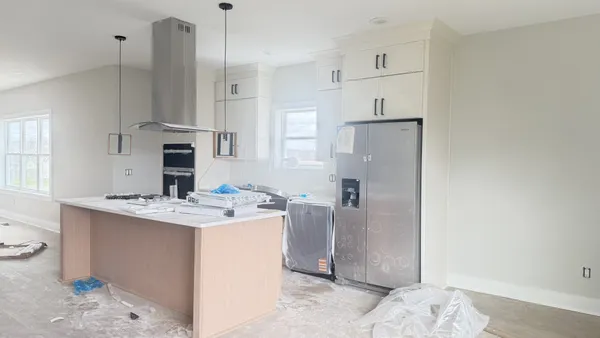a view of kitchen with sink and refrigerator
