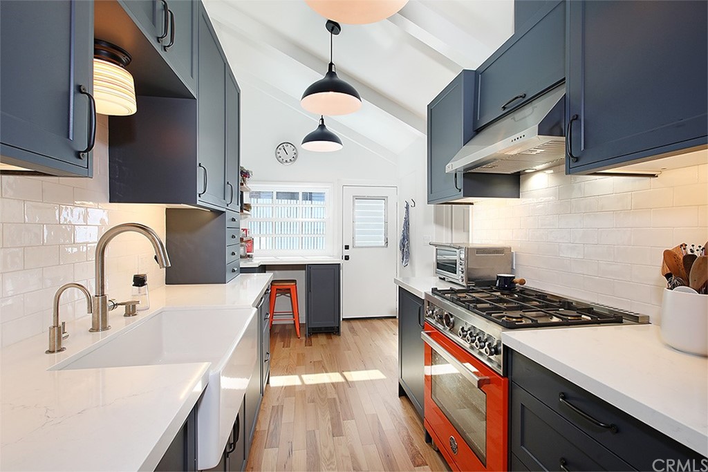 535 Through Street Laguna Beach, CA 92651 - Photo 6 of 23 a kitchen with stainless steel appliances a sink a stove and a wooden floors