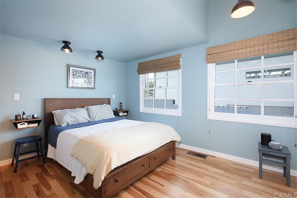 535 Through Street Laguna Beach, CA 92651 - Photo 8 of 23 a large bed sitting in a bedroom next to a window