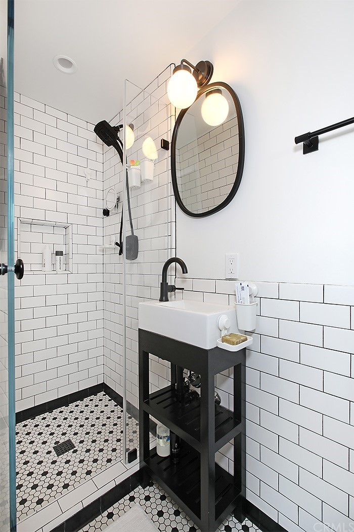 535 Through Street Laguna Beach, CA 92651 - Photo 9 of 23 a bathroom with a sink a toilet and a mirror