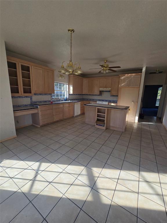 6559 Fm 2068 Commerce, TX 75428 - Photo 14 of 35 a kitchen with stainless steel appliances kitchen island granite countertop a sink and cabinets