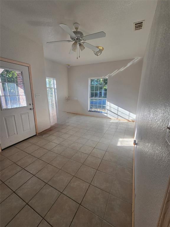 6559 Fm 2068 Commerce, TX 75428 - Photo 16 of 35 an empty room with windows and fan