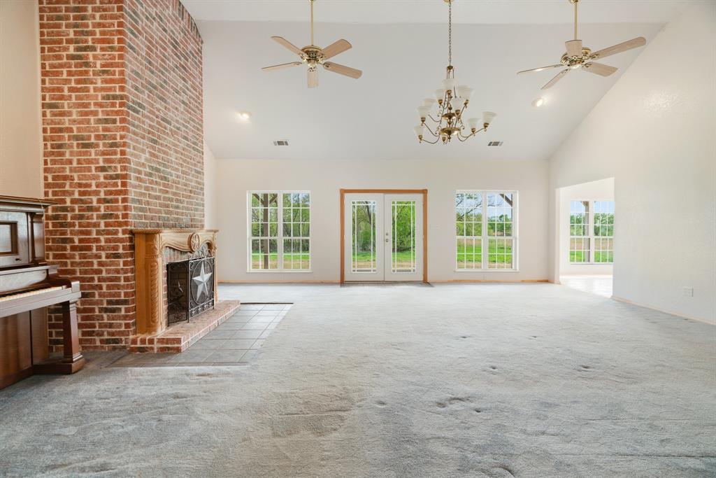 6559 Fm 2068 Commerce, TX 75428 - Photo 18 of 40 a view of an empty room with a fireplace and a window