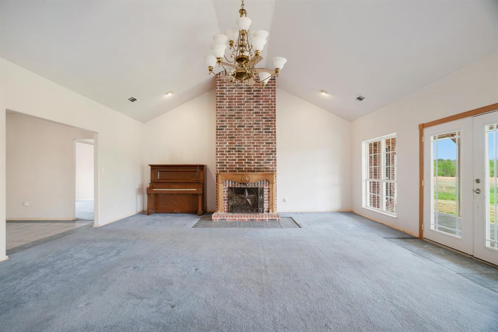 6559 Fm 2068 Commerce, TX 75428 - Photo 19 of 40 a view of a livingroom with a fireplace cabinet and windows
