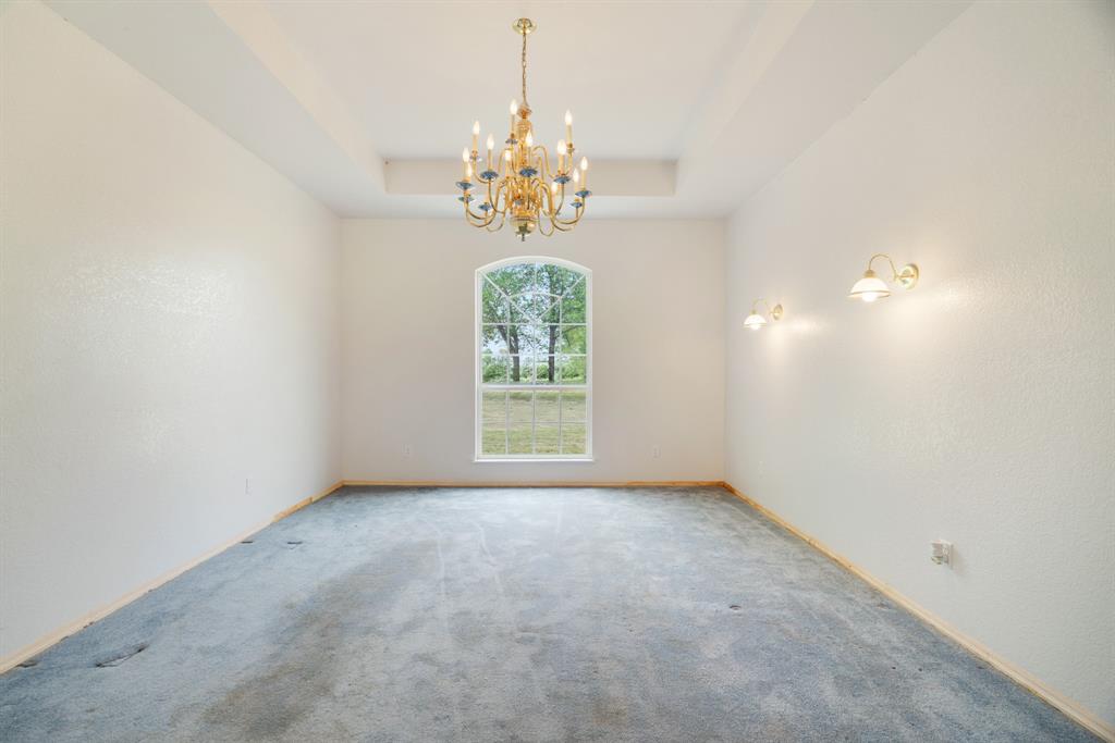 6559 Fm 2068 Commerce, TX 75428 - Photo 20 of 40 an empty room with windows and chandelier