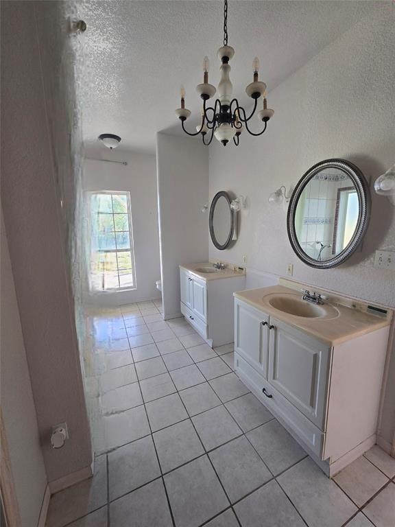 6559 Fm 2068 Commerce, TX 75428 - Photo 21 of 35 a bathroom with a granite countertop sink a mirror and a window