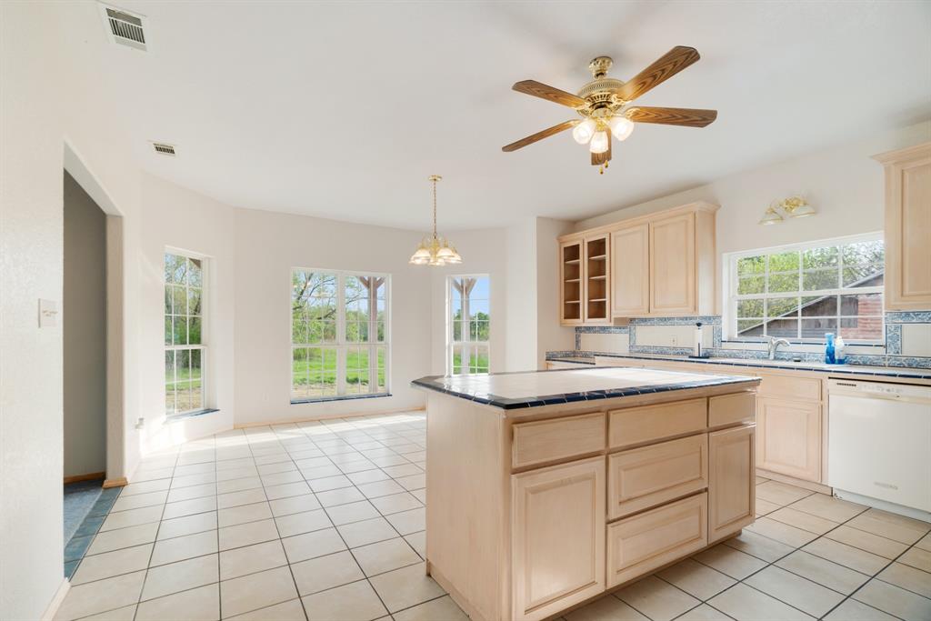 6559 Fm 2068 Commerce, TX 75428 - Photo 22 of 40 a view of a kitchen with a sink and windows