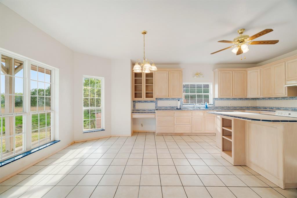 6559 Fm 2068 Commerce, TX 75428 - Photo 23 of 40 a large kitchen with granite countertop a stove a sink and a granite counter tops