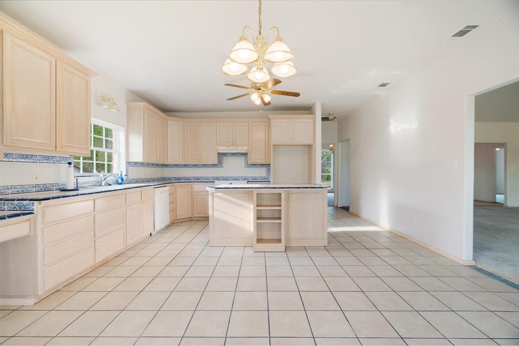6559 Fm 2068 Commerce, TX 75428 - Photo 24 of 40 a kitchen with stainless steel appliances a sink a stove a microwave and cabinets