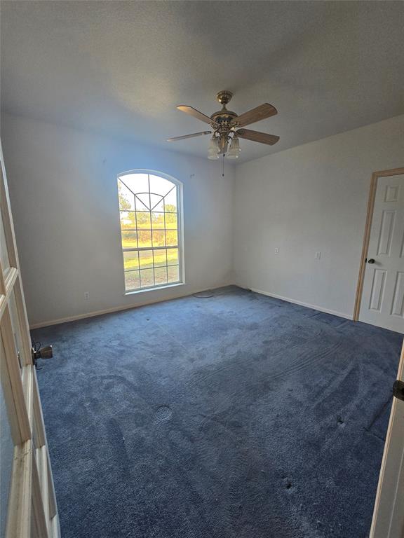 6559 Fm 2068 Commerce, TX 75428 - Photo 25 of 35 an empty room with windows and fan view
