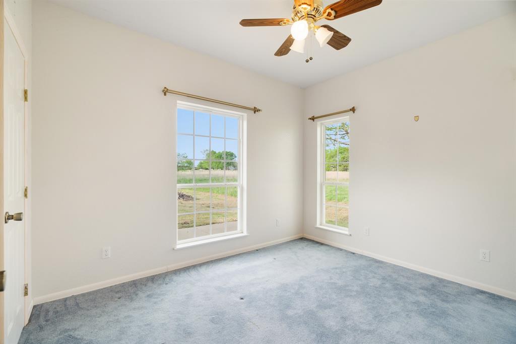 6559 Fm 2068 Commerce, TX 75428 - Photo 27 of 40 an empty room with windows and fan