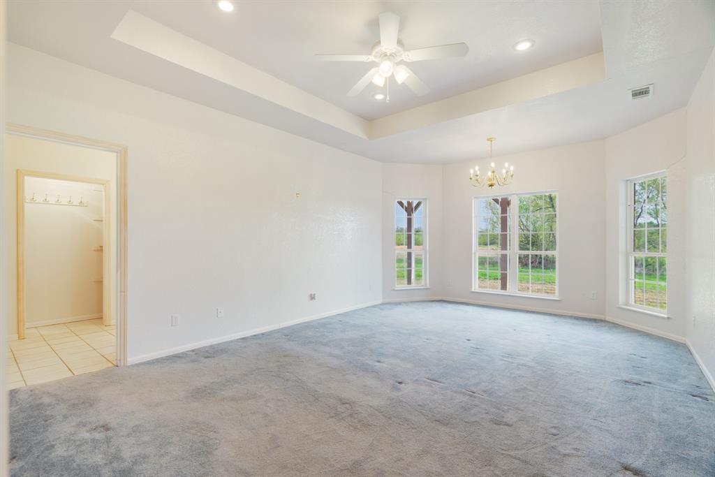 6559 Fm 2068 Commerce, TX 75428 - Photo 29 of 40 an empty room with windows and ceiling fan