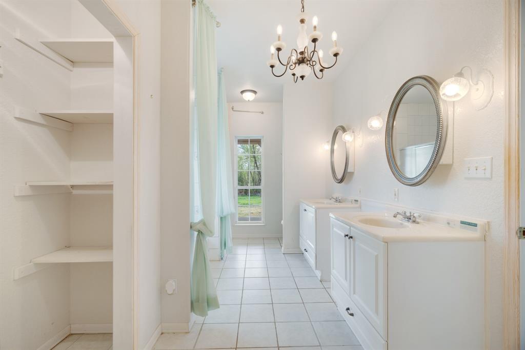 6559 Fm 2068 Commerce, TX 75428 - Photo 30 of 40 a bathroom with a double vanity sink mirror and shower
