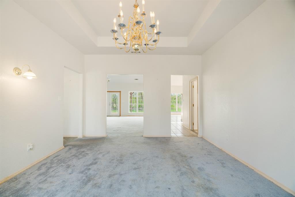 6559 Fm 2068 Commerce, TX 75428 - Photo 33 of 40 en empty room with windows and chandelier