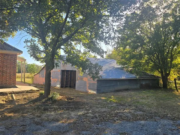 a view of a house with a yard and tree