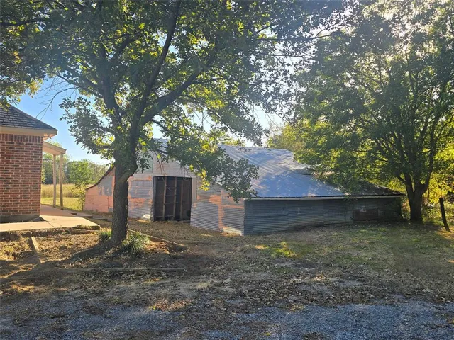 a view of a house with a yard and tree