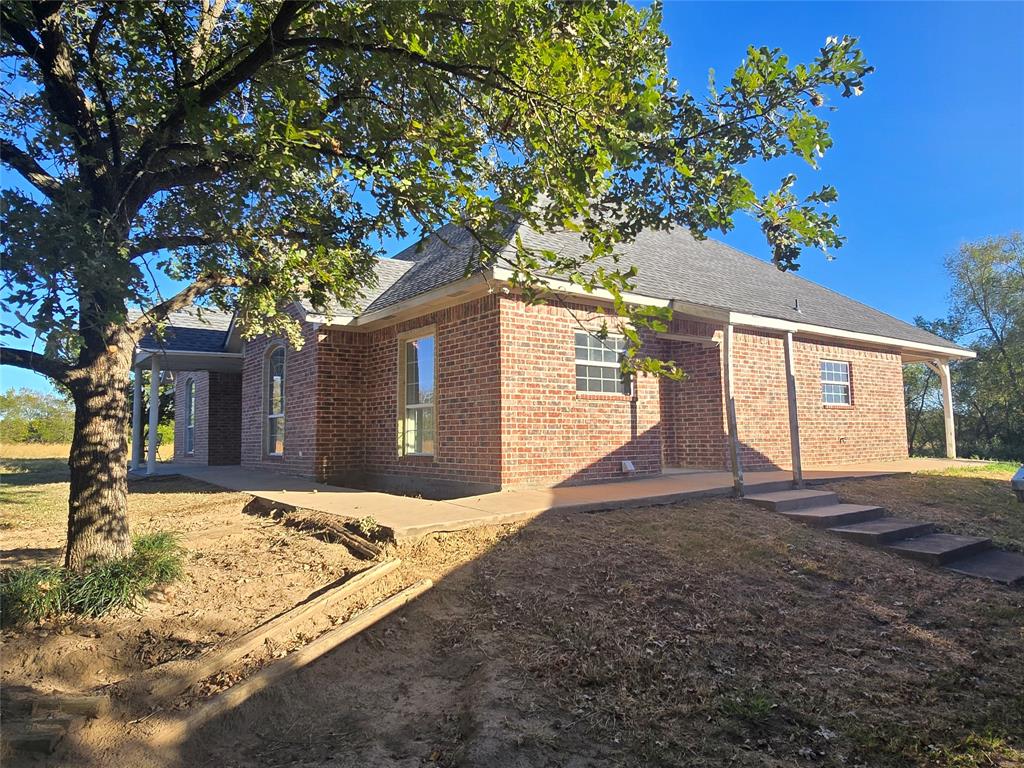 6559 Fm 2068 Commerce, TX 75428 - Photo 8 of 35 a front view of a house with a yard