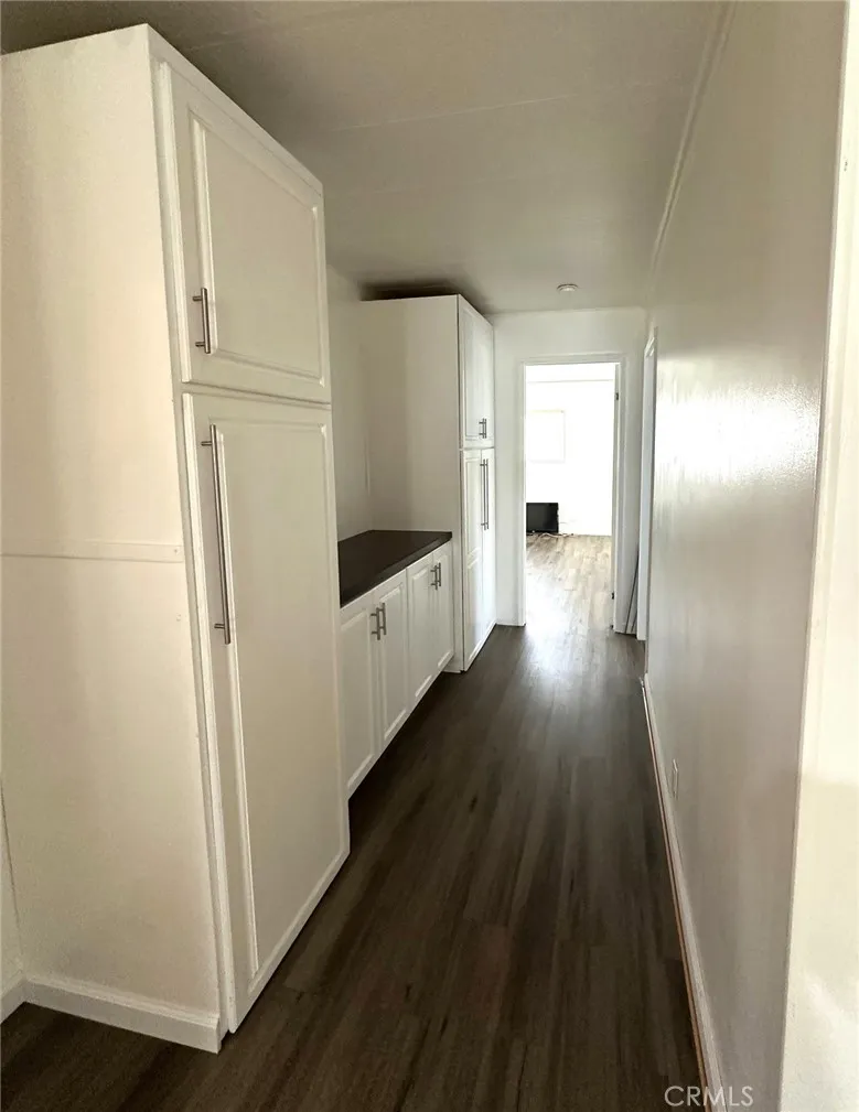 15181 Van Buren, Unit 57 Riverside, CA 92501 - Photo 11 of 38 a view of a hallway with wooden floor