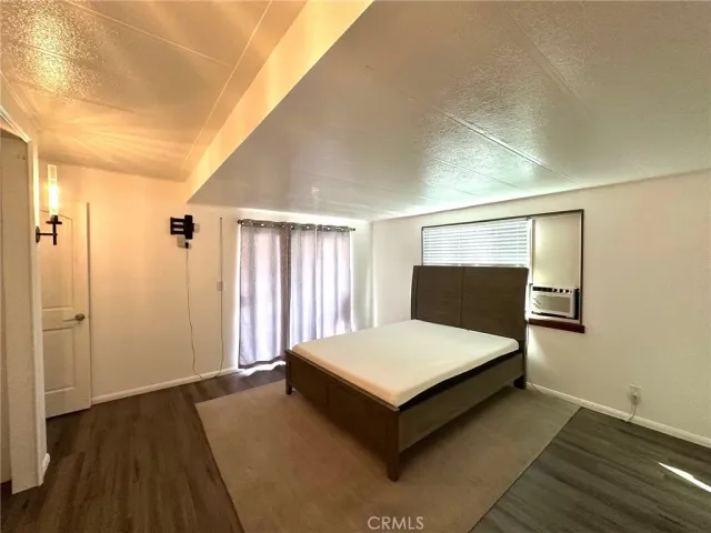 a spacious bedroom with a bed and window