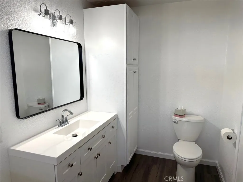 15181 Van Buren, Unit 57 Riverside, CA 92504 - Photo 18 of 38 a bathroom with a sink toilet and a mirror