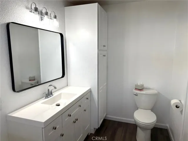 a bathroom with a sink toilet and a mirror