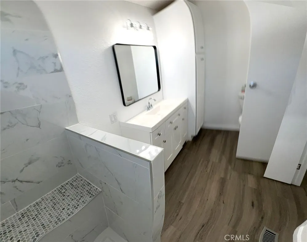 15181 Van Buren, Unit 57 Riverside, CA 92504 - Photo 20 of 38 a bathroom with a mirror and a sink