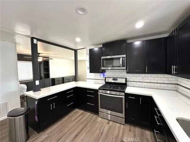 a kitchen with a sink stove and microwave