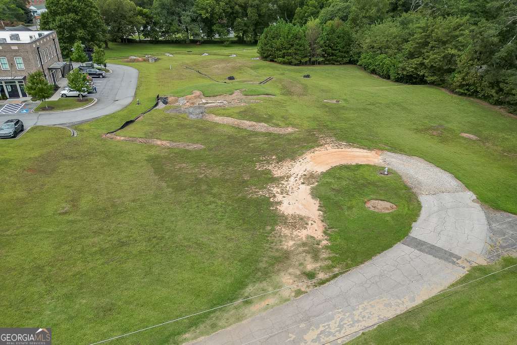 208 Pirkle Ferry Road Cumming, GA 30040 - Photo 9 of 14 a view of a swimming pool with a yard and trees in the background