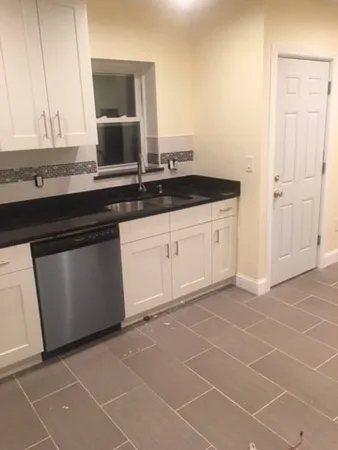 a kitchen with a sink and cabinets