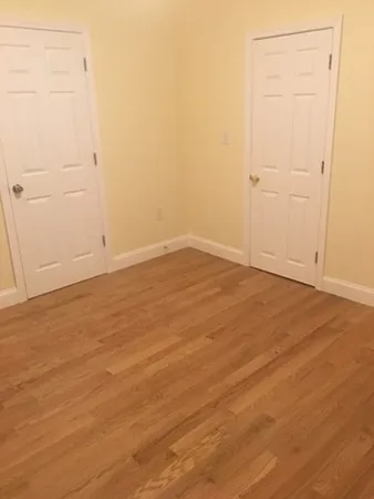 an empty room with wooden floor