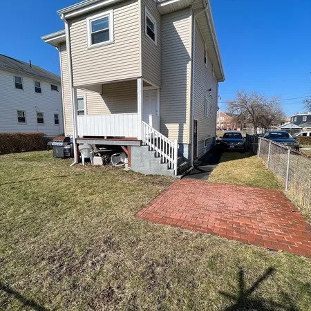 a view of a house with backyard and sitting area