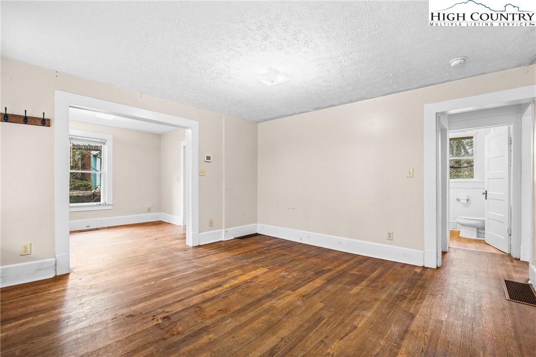 192-206 Orchard Street Boone, NC 28607 - Photo 24 of 50 a view of an empty room with wooden floor and a window
