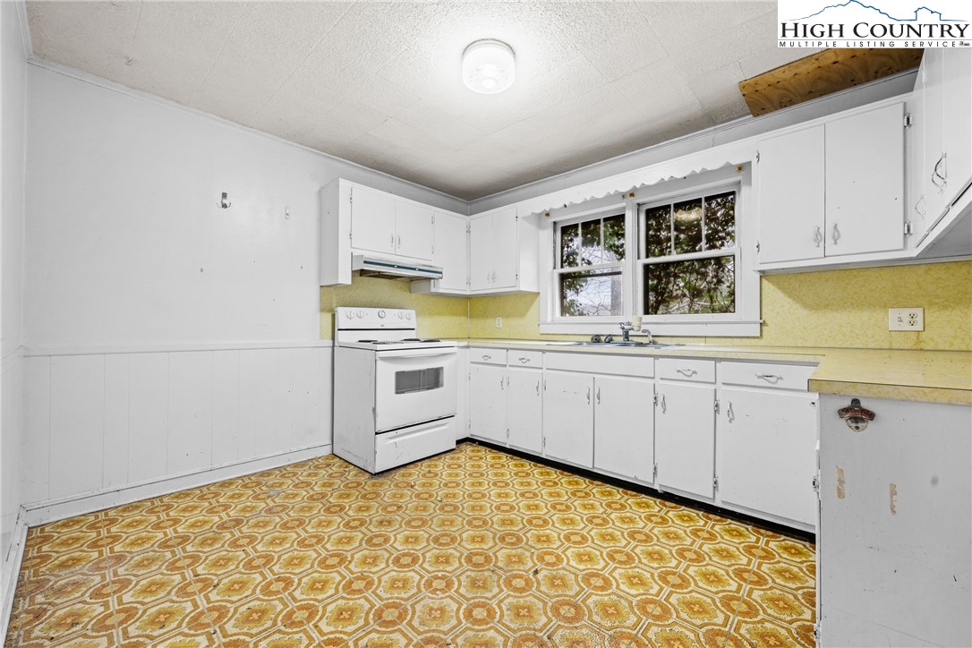192-206 Orchard Street Boone, NC 28607 - Photo 41 of 50 a kitchen with granite countertop white cabinets and white appliances