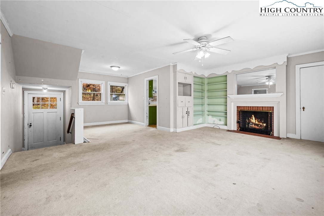 192-206 Orchard Street Boone, NC 28607 - Photo 8 of 50 a view of a livingroom with an empty space and a fireplace