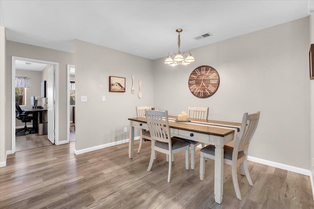 2110 Gentry Way Red Bluff, CA 96080 - Photo 10 of 47 a view of a dining room with furniture wooden floor and a chandelier