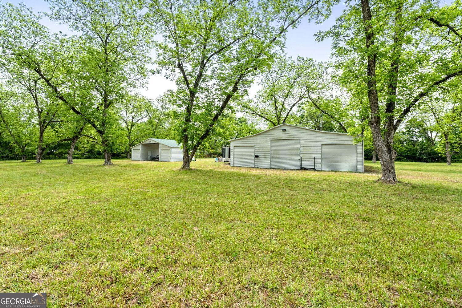 117 Zebulon Street Milner, GA 30257 - Photo 11 of 24 a house with huge green field and trees