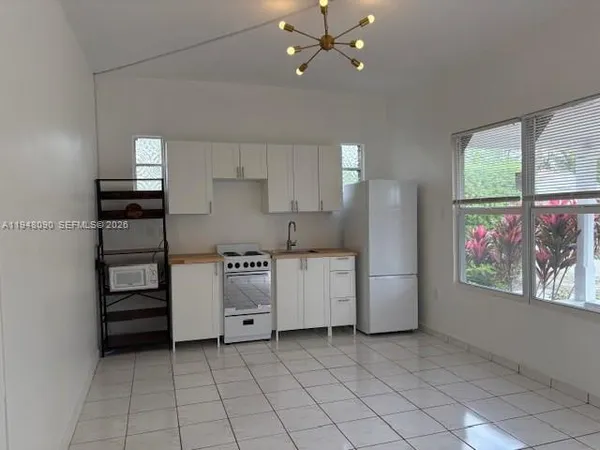 a kitchen with a refrigerator and window