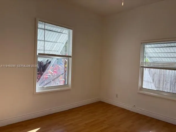 an empty room with windows and closet